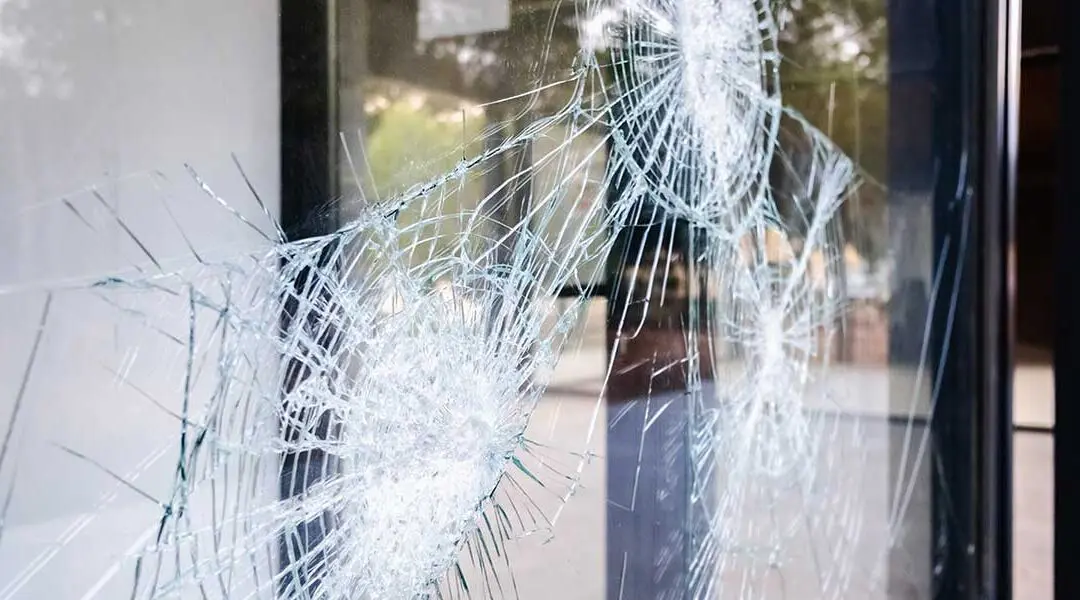 broken window by bullets, signs you need window replacement - Columbia Glass and Mirror